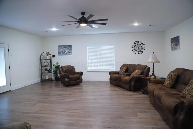 a living room with furniture and a wooden floor