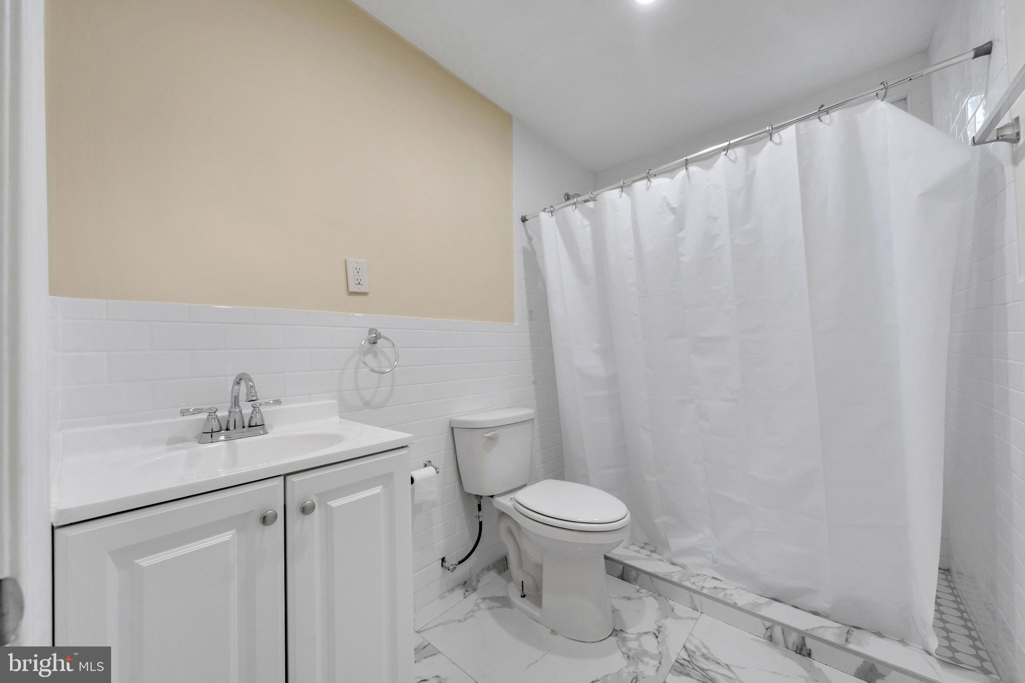 724 Hunter Street Gloucester City, NJ 08030 - Photo 12 of 47 a bathroom with a sink a toilet and vanity