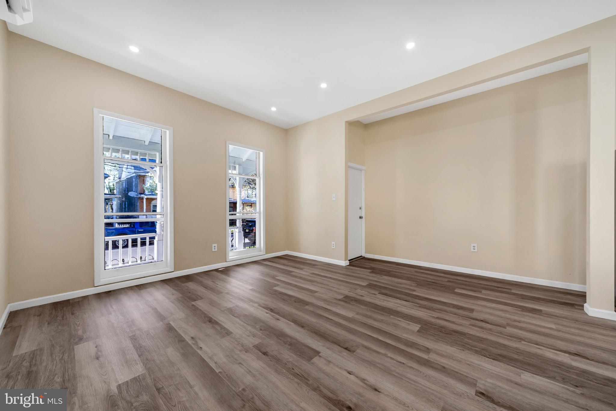724 Hunter Street Gloucester City, NJ 08030 - Photo 13 of 47 a view of an empty room with wooden floor and a window