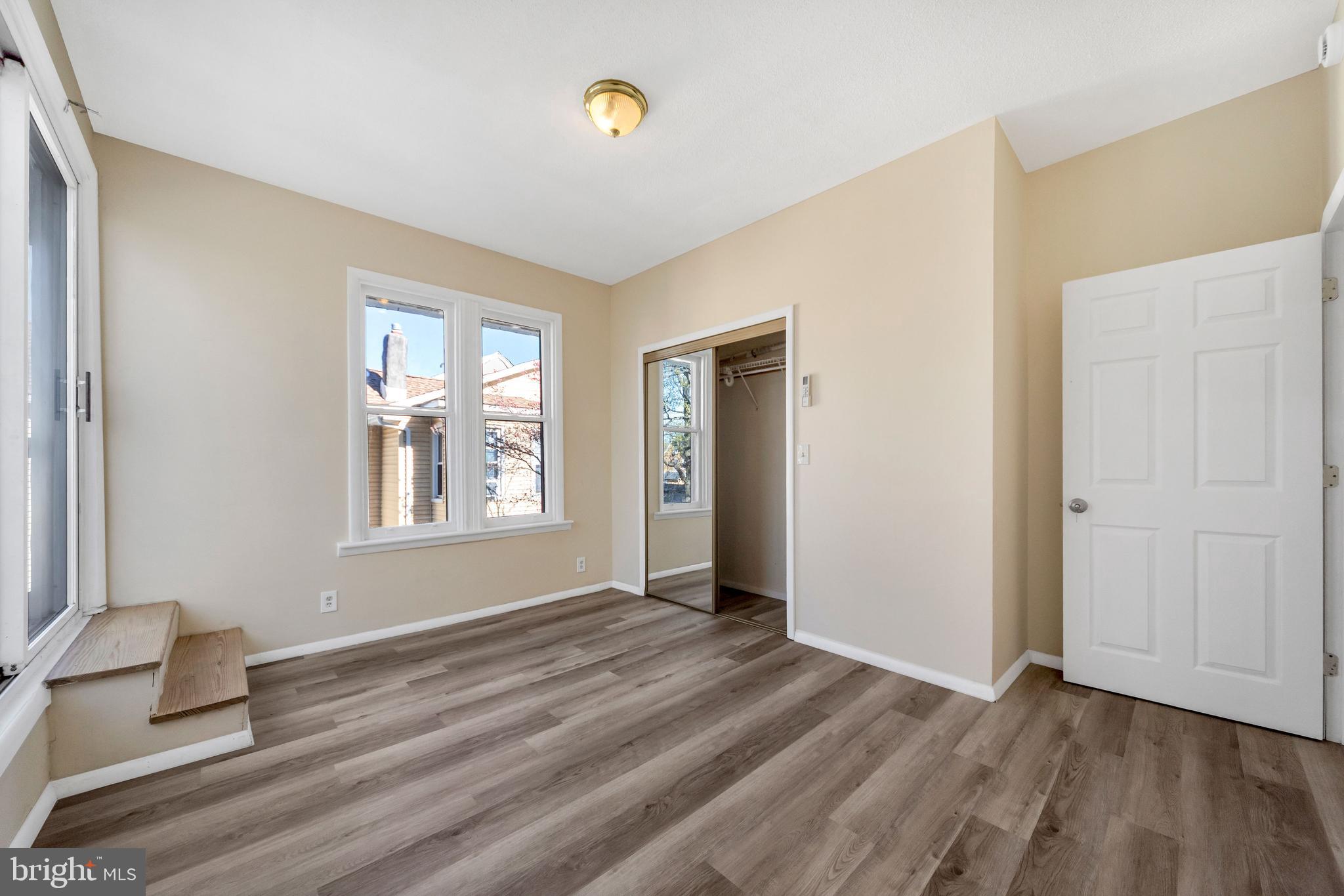 724 Hunter Street Gloucester City, NJ 08030 - Photo 22 of 47 a view of an empty room with window and wooden floor