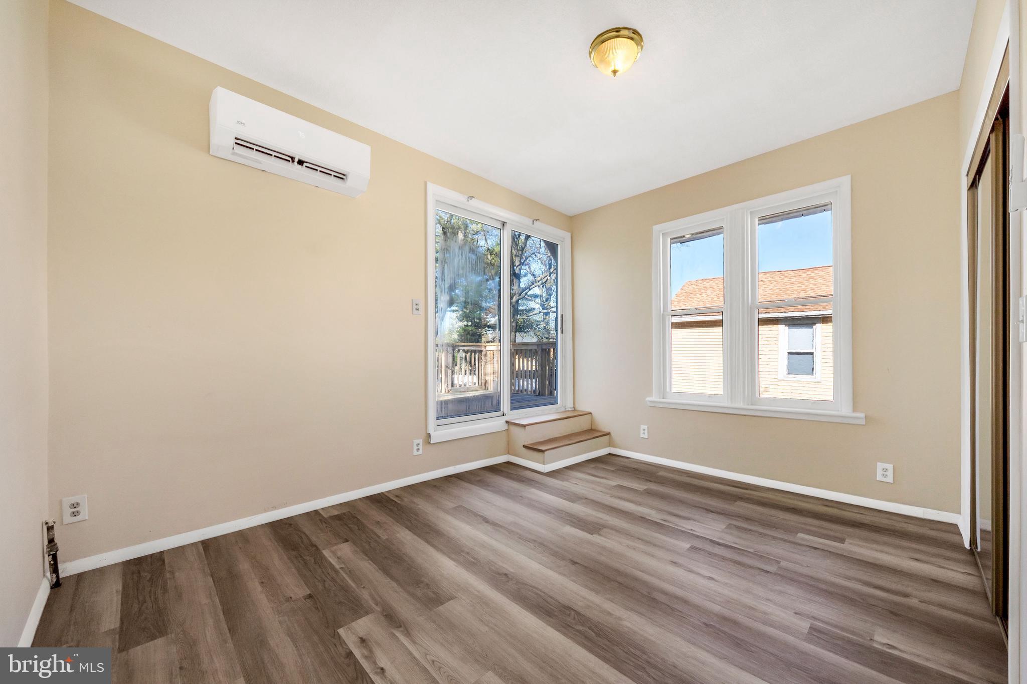 724 Hunter Street Gloucester City, NJ 08030 - Photo 23 of 47 a view of an empty room with wooden floor and a window