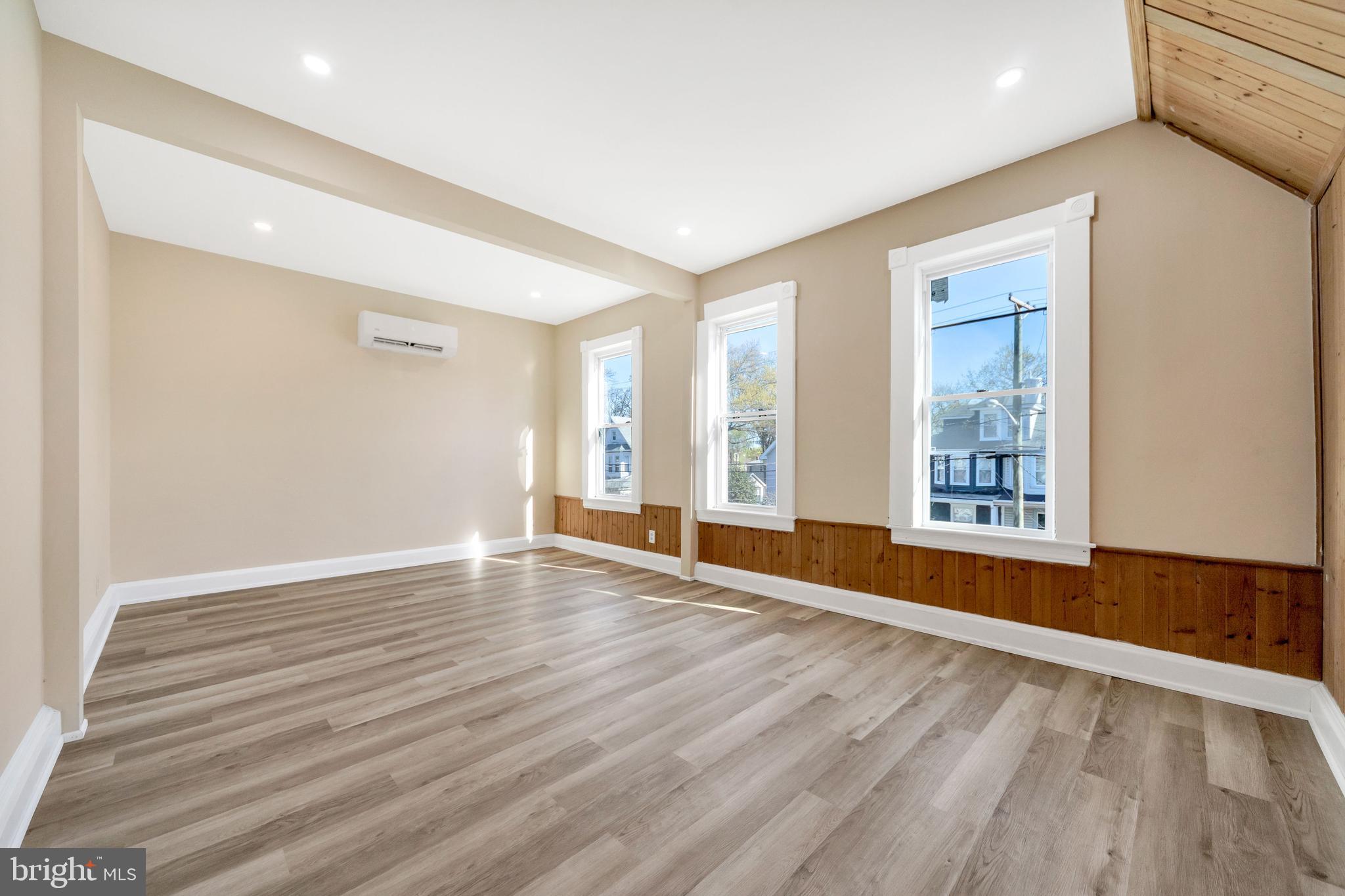 724 Hunter Street Gloucester City, NJ 08030 - Photo 27 of 47 a view of an empty room with wooden floor and a window