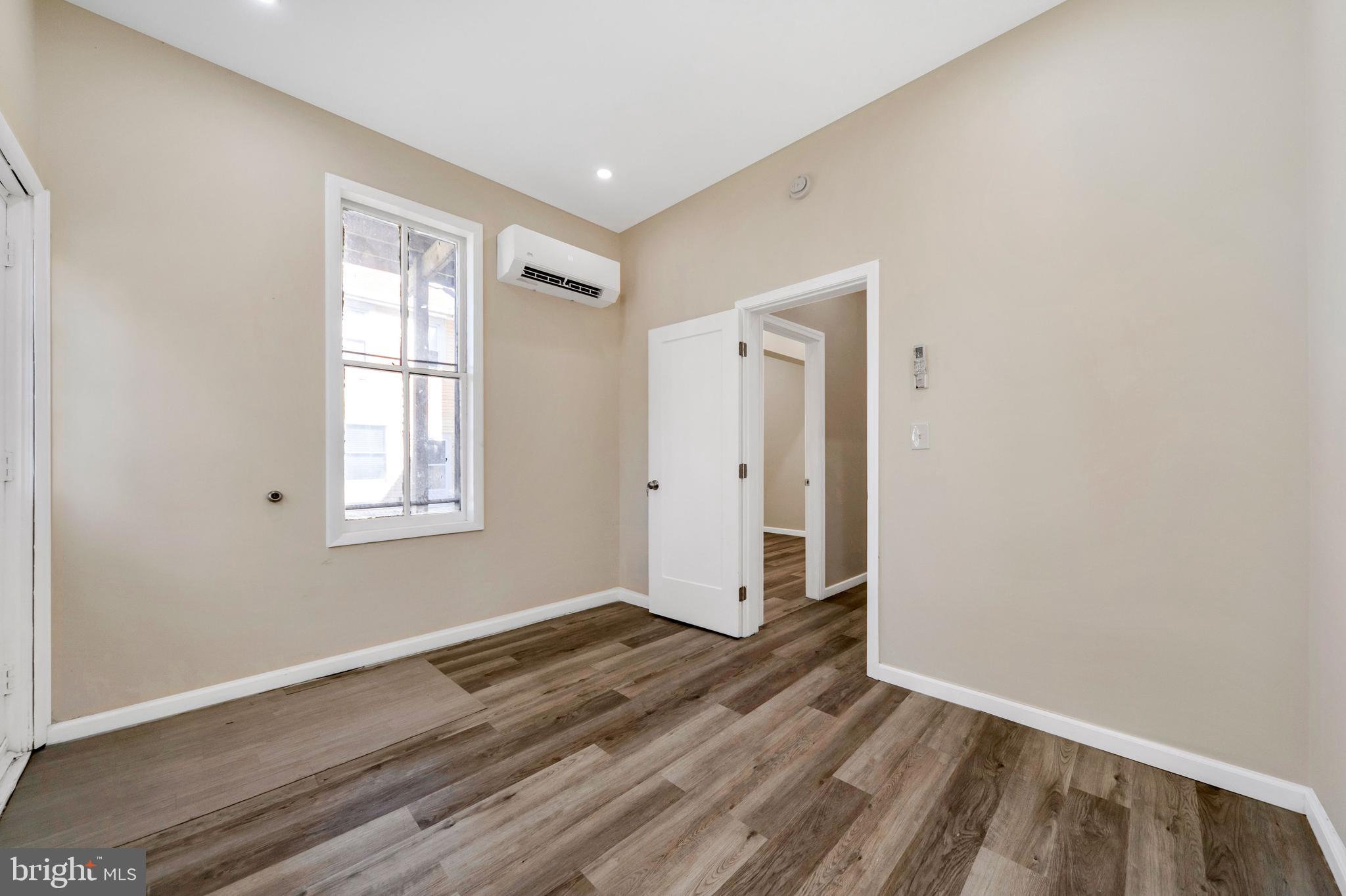 724 Hunter Street Gloucester City, NJ 08030 - Photo 28 of 47 an empty room with wooden floor and windows