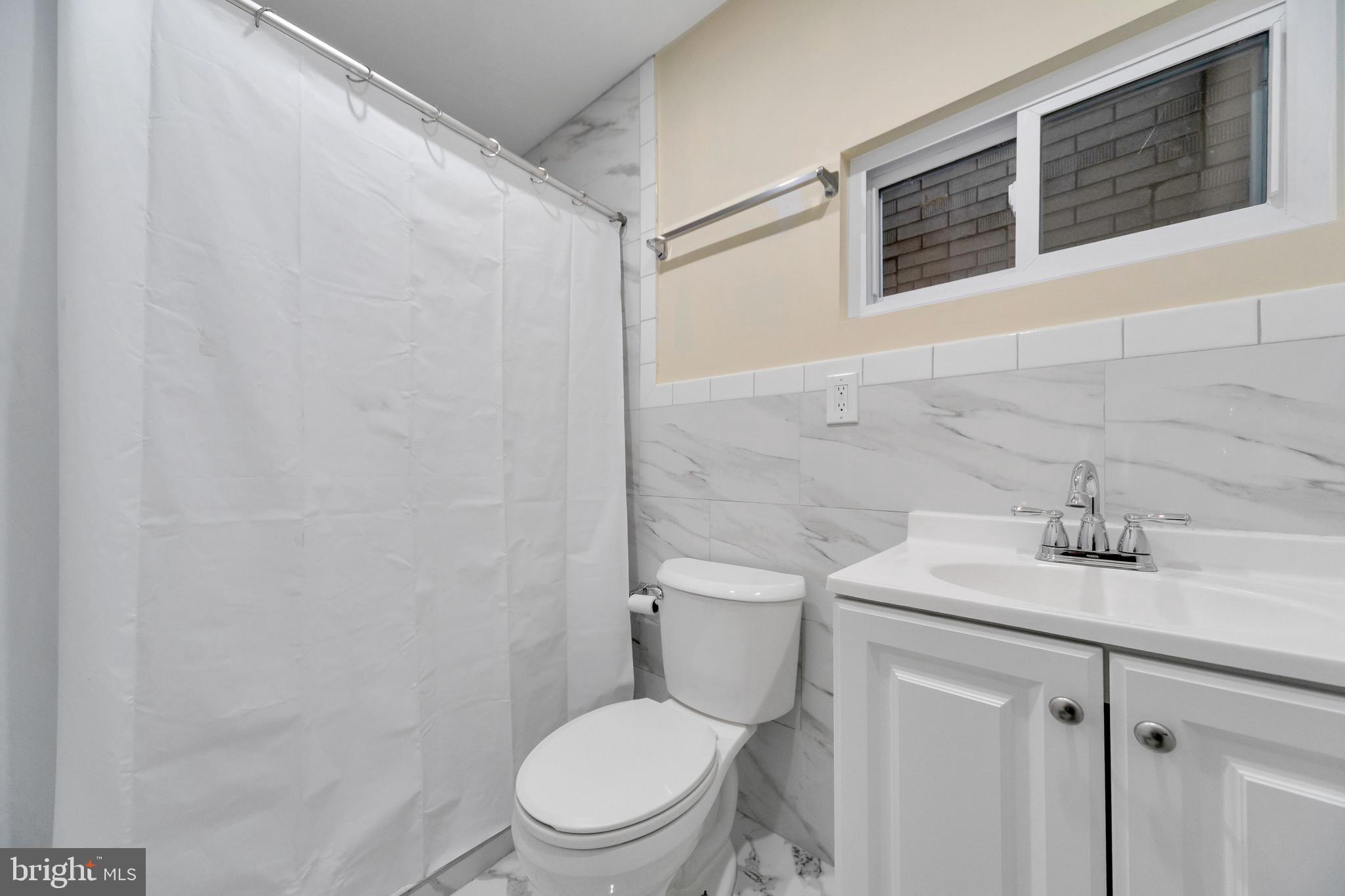 724 Hunter Street Gloucester City, NJ 08030 - Photo 31 of 47 a white toilet sitting next to a bathroom sink