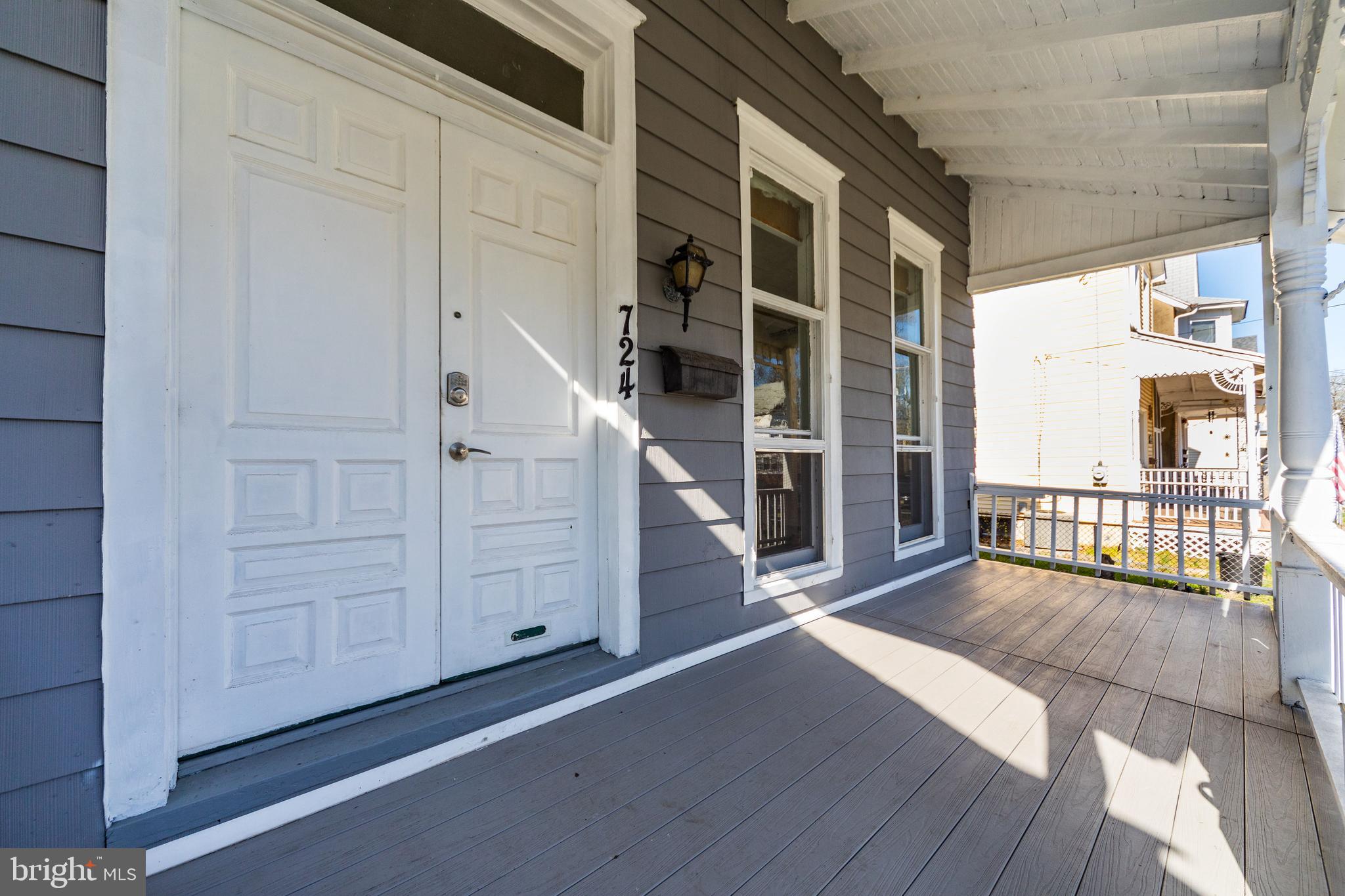 724 Hunter Street Gloucester City, NJ 08030 - Photo 4 of 47 a view of a balcony with wooden floor and fence