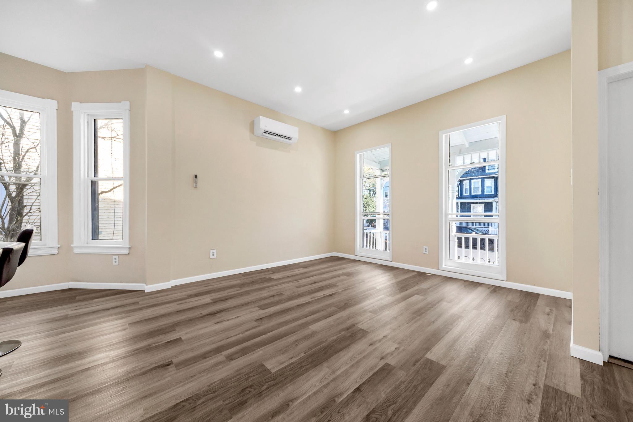 724 Hunter Street Gloucester City, NJ 08030 - Photo 6 of 47 a view of an empty room with wooden floor and windows