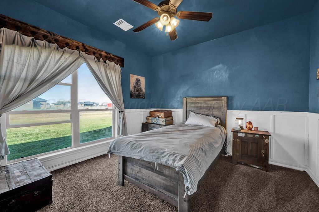 17801 Stone Creek Road Amarillo, TX 79124 - Photo 22 of 31 a bedroom with a bed and a large window