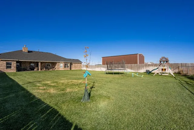 a backyard of a house with table and chairs