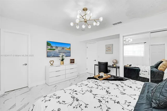 a bed room with a bed and a dresser