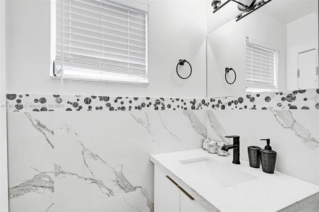 a bathroom with a sink and a mirror