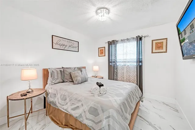 a large white bed in a white room