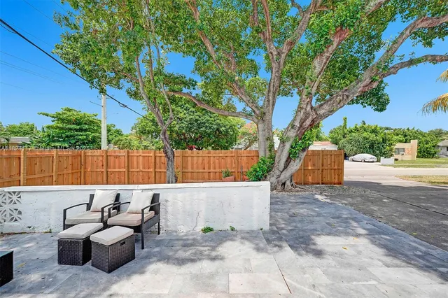 a view of a patio with couches and a fire pit