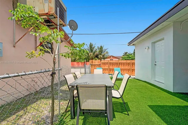 a view of balcony with a table and chairs