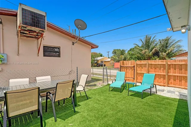 a view of a chair and table in backyard