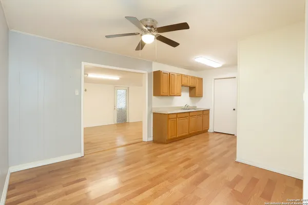 a view of a kitchen with a sink and a refrigerator