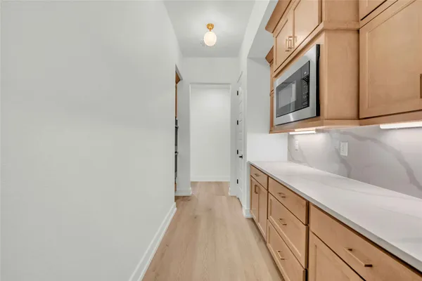 a bathroom with granite countertop a sink and a bathtub