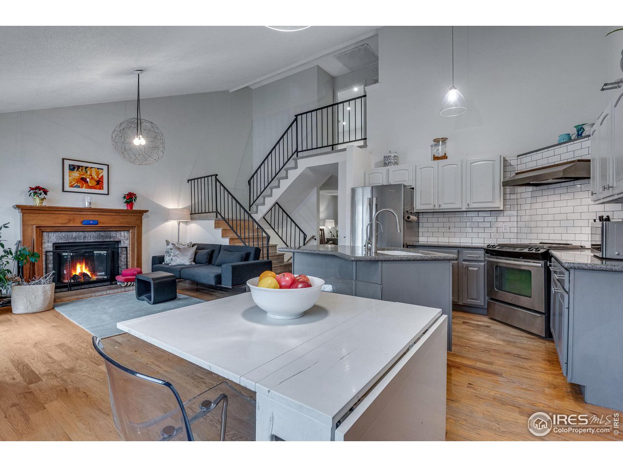 908 Clover Circle Lafayette, CO 80026 - Photo 14 of 40 a kitchen with a sink a stove and chairs