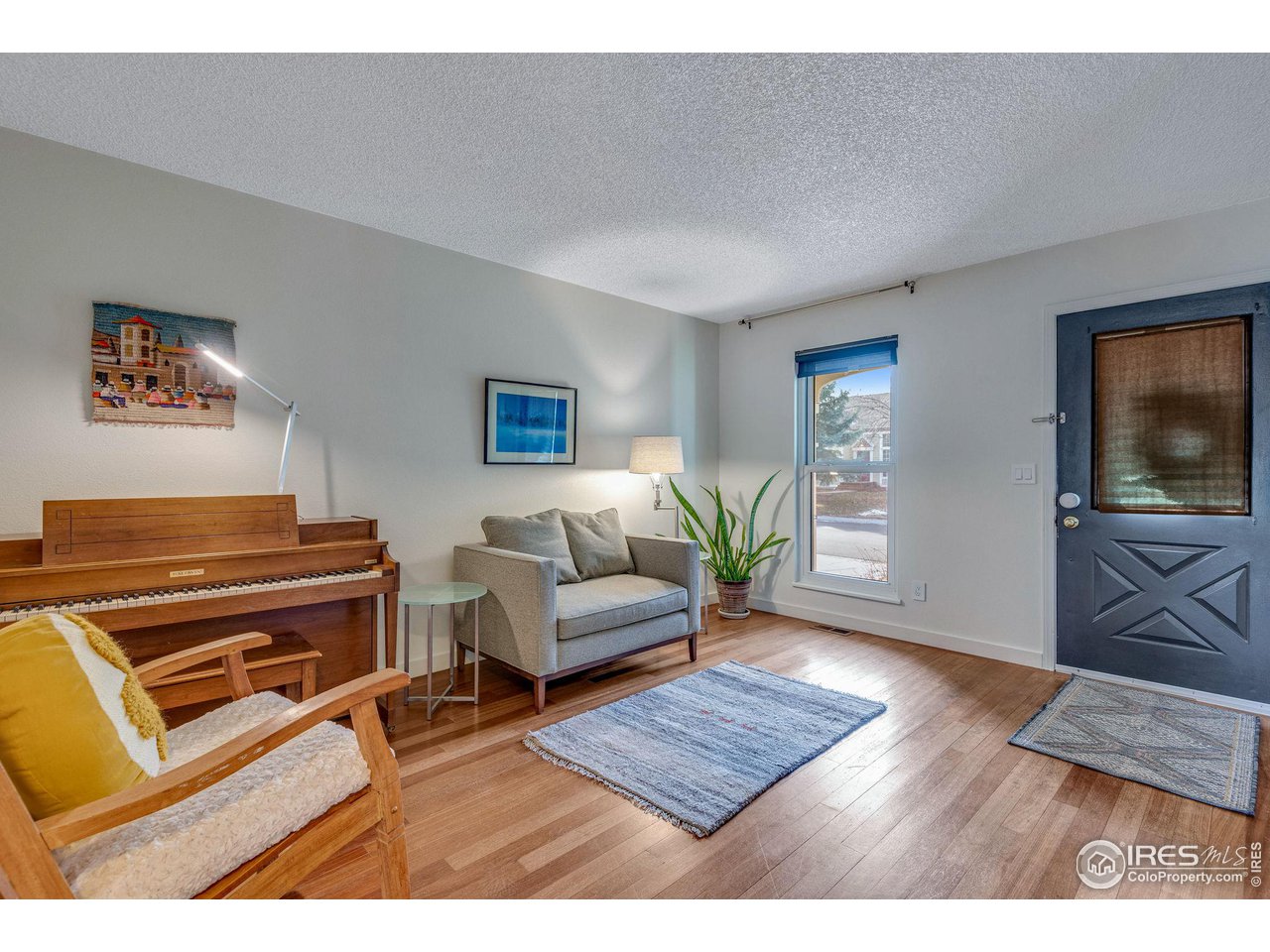 908 Clover Circle Lafayette, CO 80026 - Photo 16 of 40 a living room with furniture and a flat screen tv