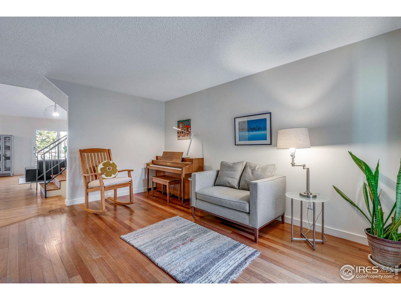 908 Clover Circle Lafayette, CO 80026 - Photo 17 of 40 a living room with furniture and a wooden floor