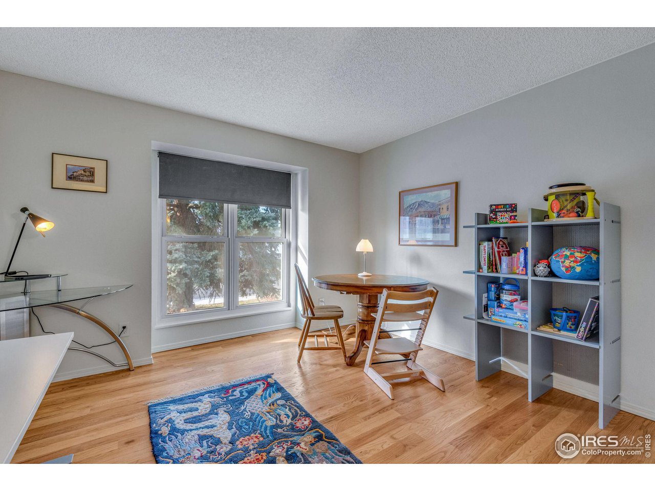908 Clover Circle Lafayette, CO 80026 - Photo 19 of 40 a living room with furniture and a book shelf