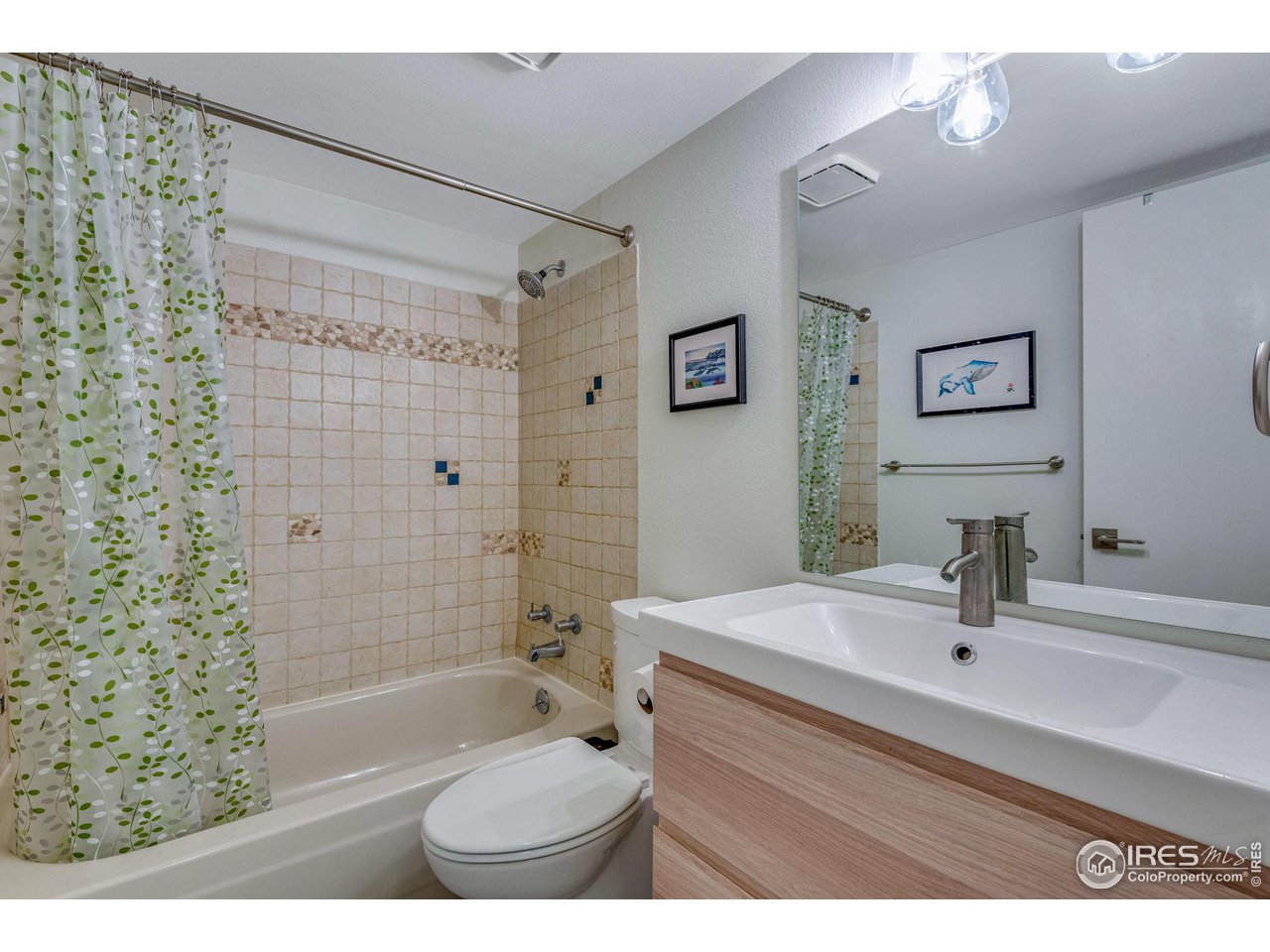 908 Clover Circle Lafayette, CO 80026 - Photo 20 of 40 a bathroom with a sink toilet a shower and a mirror