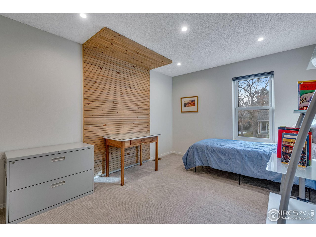 908 Clover Circle Lafayette, CO 80026 - Photo 21 of 40 a bedroom with a bed and a dresser