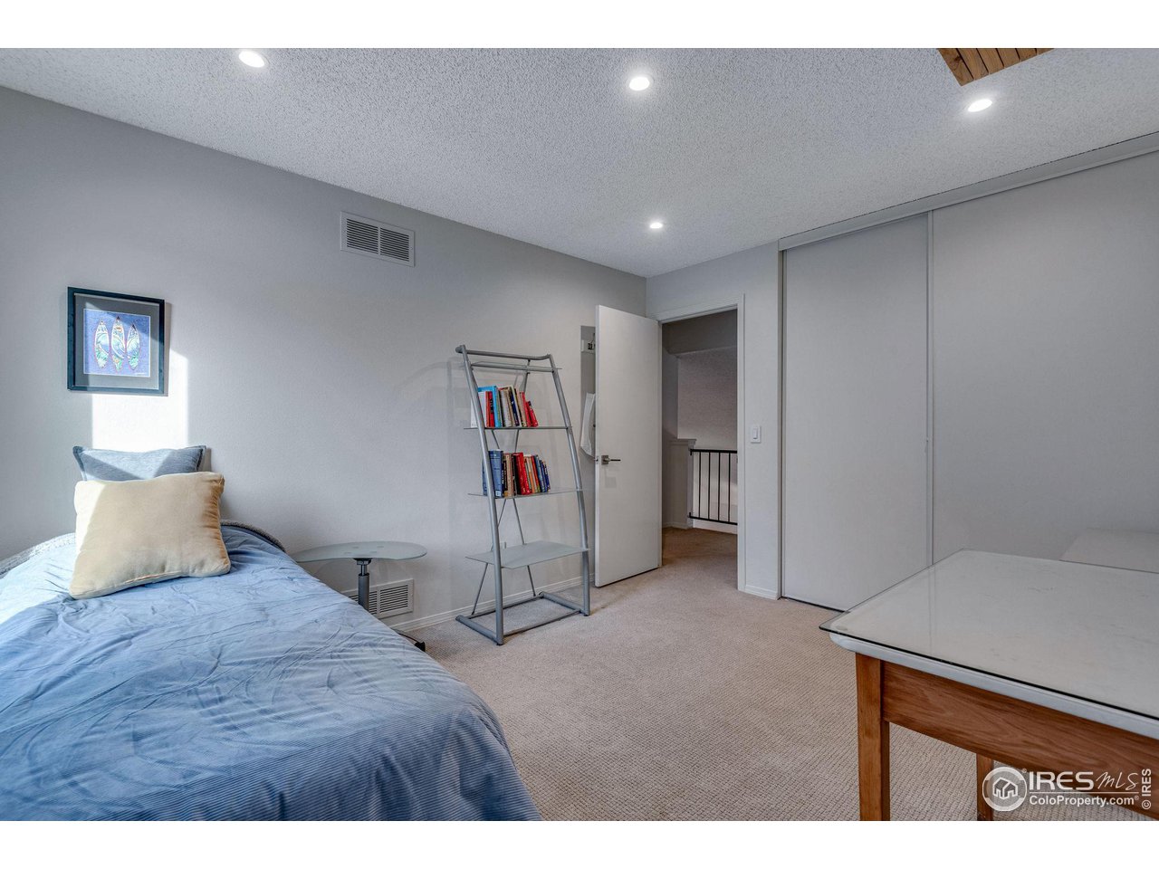 908 Clover Circle Lafayette, CO 80026 - Photo 23 of 40 a bedroom with a bed and cabinets