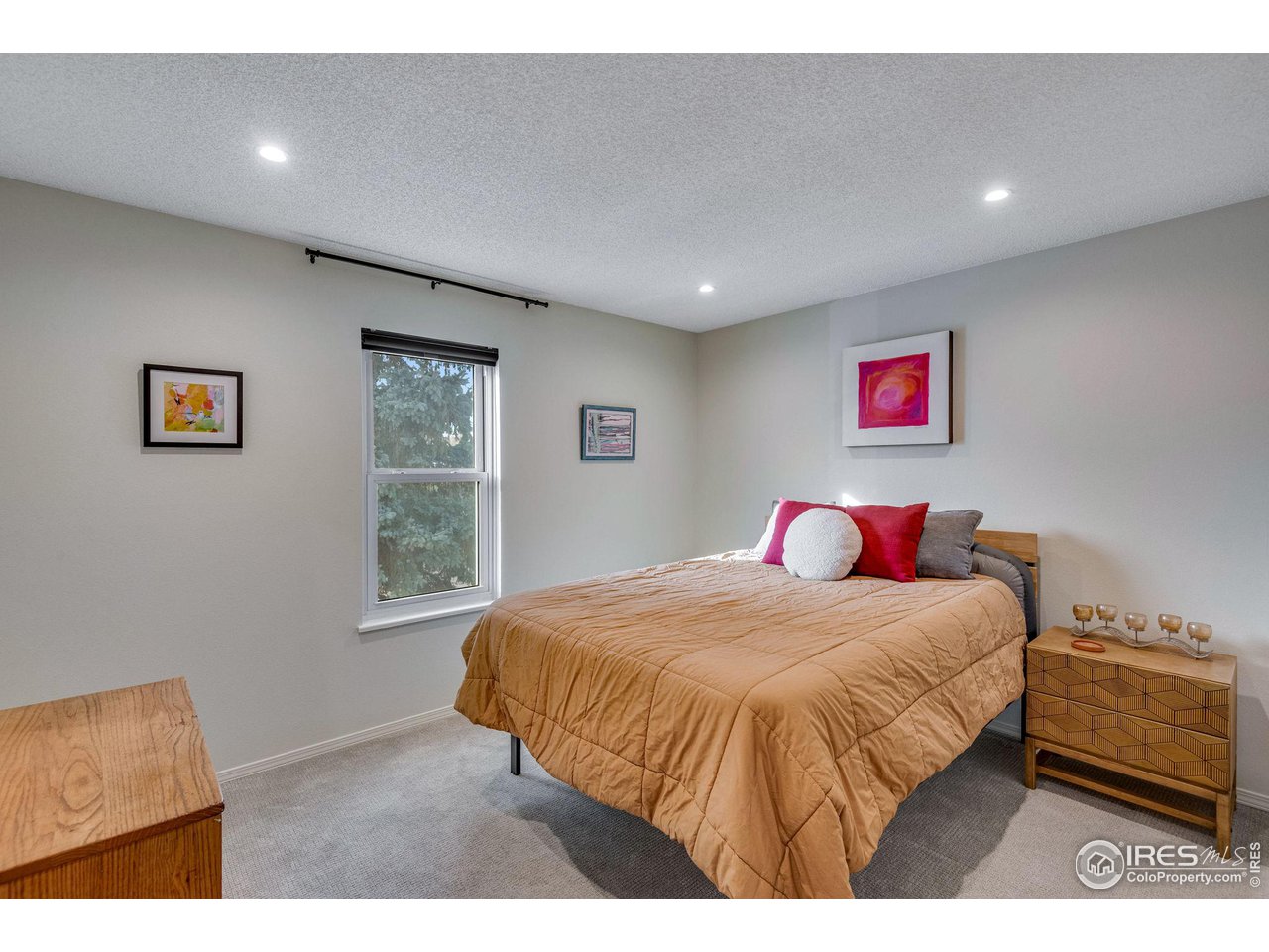 908 Clover Circle Lafayette, CO 80026 - Photo 25 of 40 a bedroom with a bed and a painting on the wall