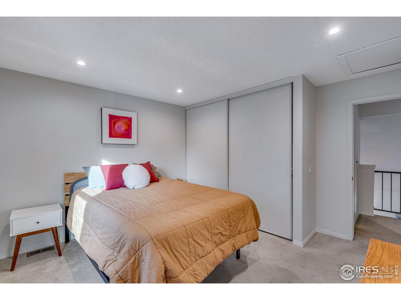 908 Clover Circle Lafayette, CO 80026 - Photo 26 of 40 a bedroom with a bed and a cabinets