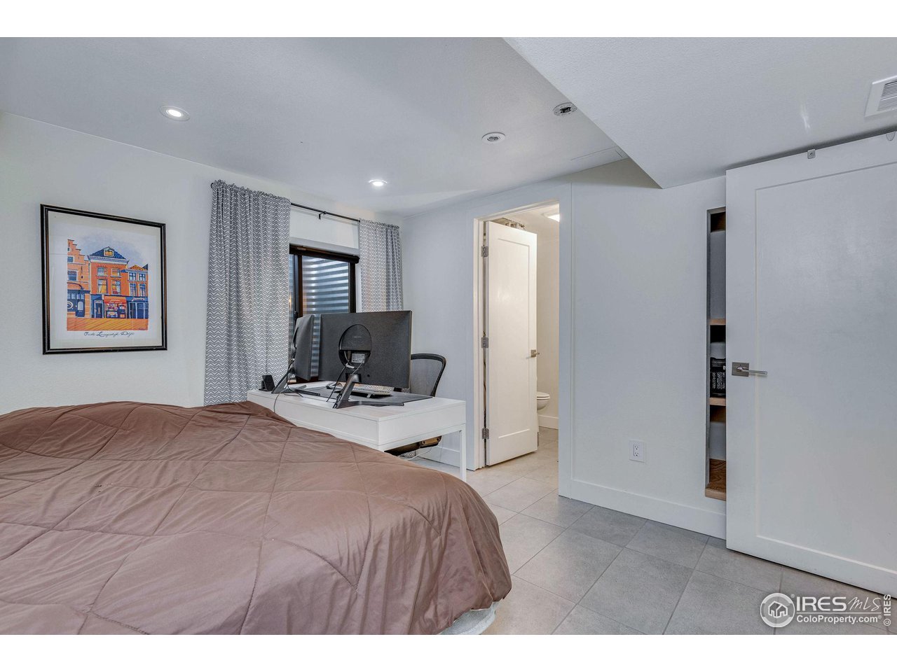 908 Clover Circle Lafayette, CO 80026 - Photo 32 of 40 a bedroom with a bed and a view of bathroom
