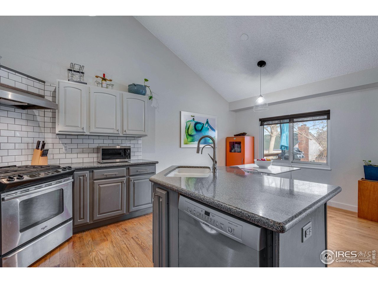 908 Clover Circle Lafayette, CO 80026 - Photo 8 of 40 a kitchen with kitchen island white cabinets a sink stove and refrigerator