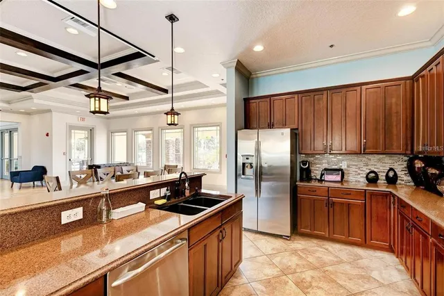 a kitchen with stainless steel appliances granite countertop a sink a stove and a refrigerator