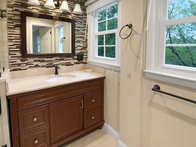 a bathroom with a sink a vanity and a mirror