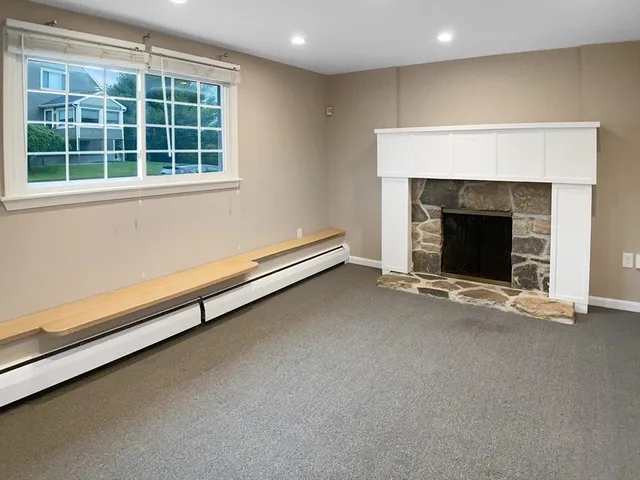 a view of an empty room with a fireplace