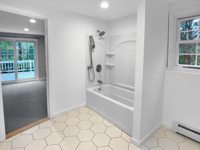 a bathroom with a bathtub and a shower