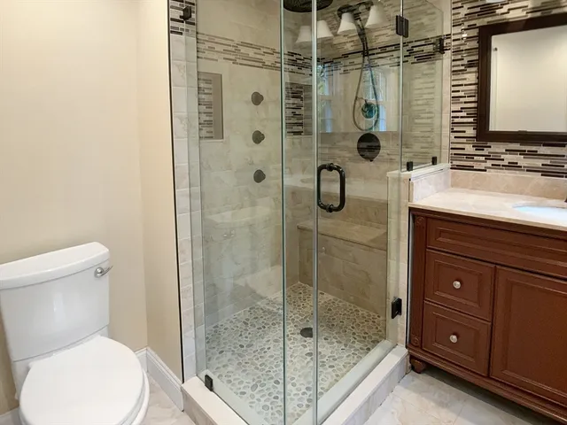 a bathroom with a shower sink and mirror