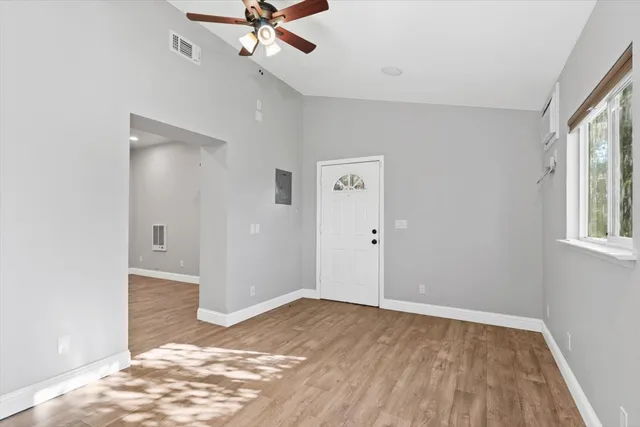 a kitchen with granite countertop a sink a stove and cabinets