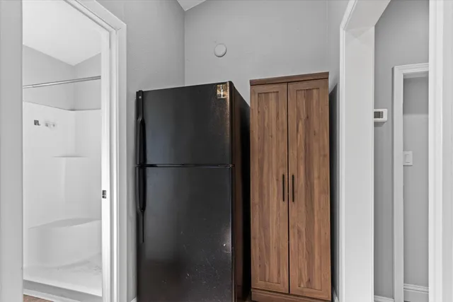 a view of a hallway with a ceiling fan