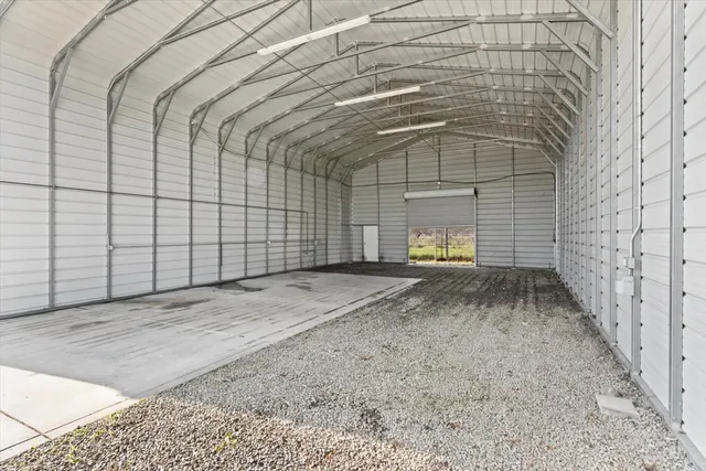 a view of a big room with wooden floor and windows in a room