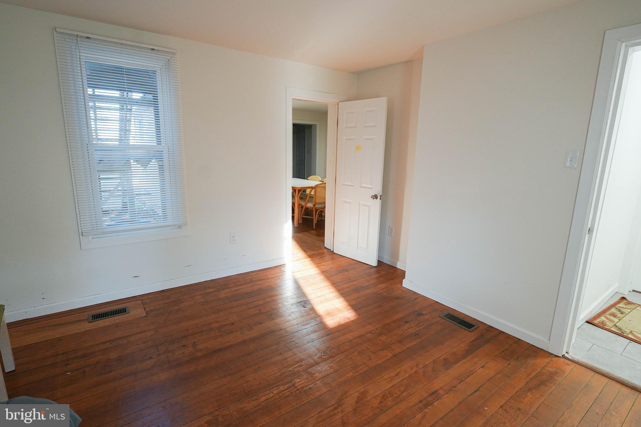231 Newton Street, Unit A Salisbury, MD 21801 - Photo 12 of 38 an empty room with wooden floor and windows