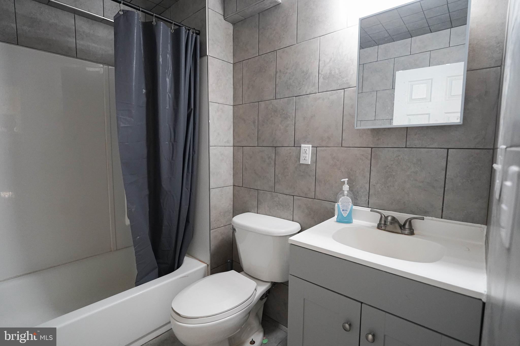 231 Newton Street, Unit A Salisbury, MD 21801 - Photo 17 of 38 a white toilet sitting next to a bathroom sink