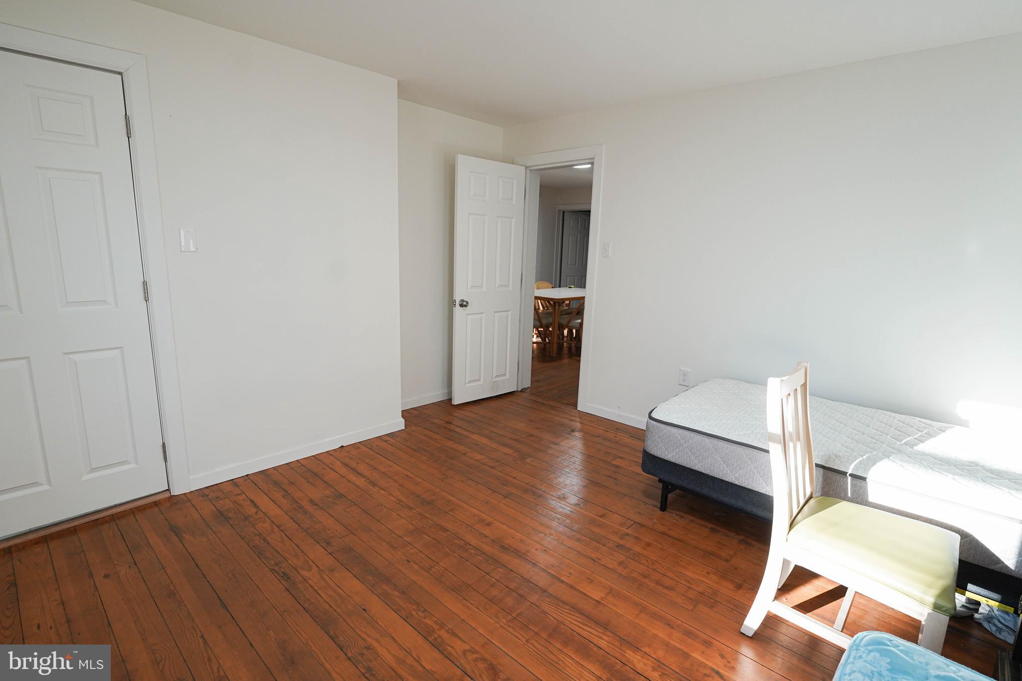 231 Newton Street, Unit A Salisbury, MD 21801 - Photo 23 of 38 a view of kitchen and empty room with wooden floor