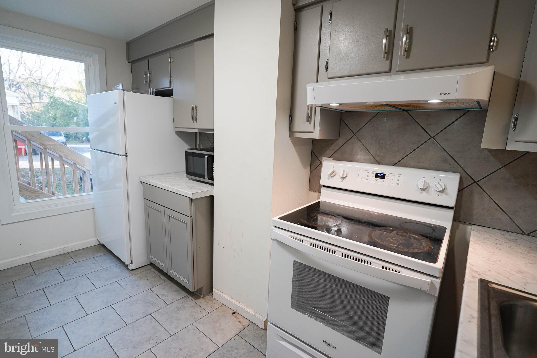 231 Newton Street, Unit A Salisbury, MD 21801 - Photo 30 of 38 a kitchen with white cabinets and white appliances