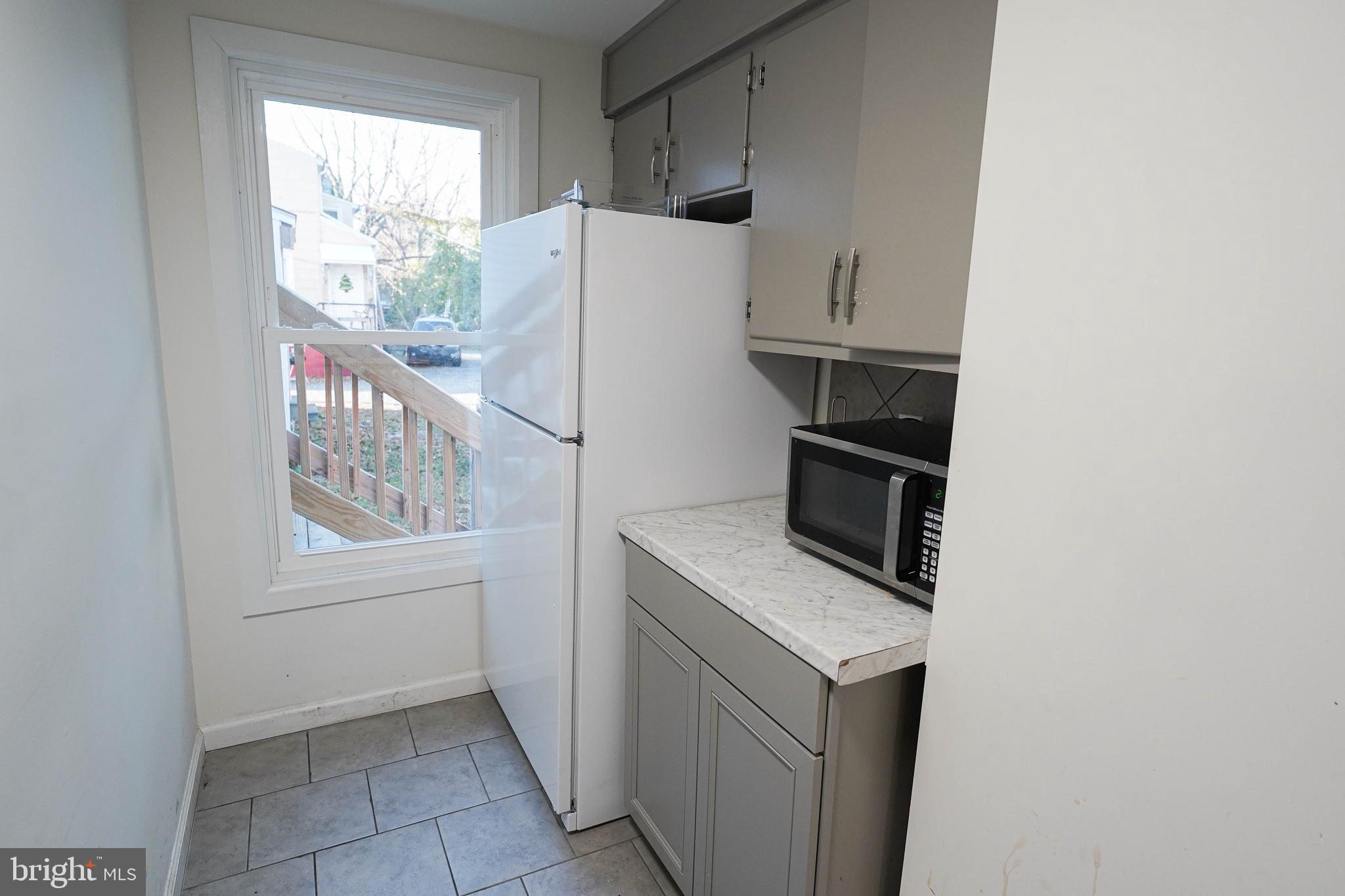 231 Newton Street, Unit A Salisbury, MD 21801 - Photo 31 of 38 a utility room with cabinets washer and dryer