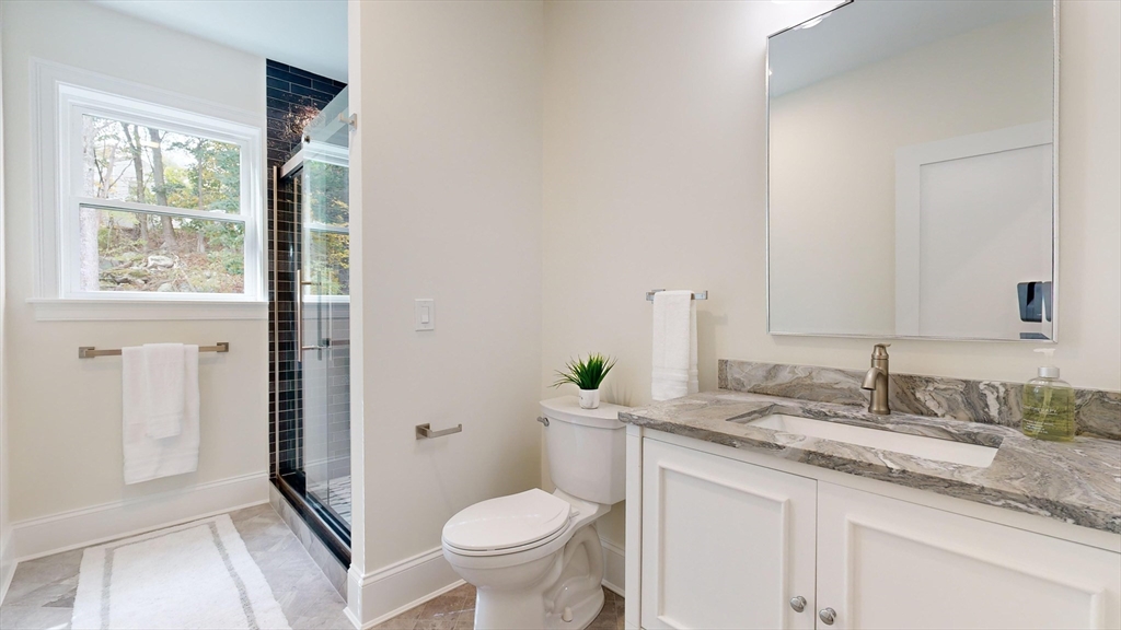 8 Charles Street North Reading, MA 01864 - Photo 17 of 42 a bathroom with a granite countertop sink toilet and mirror