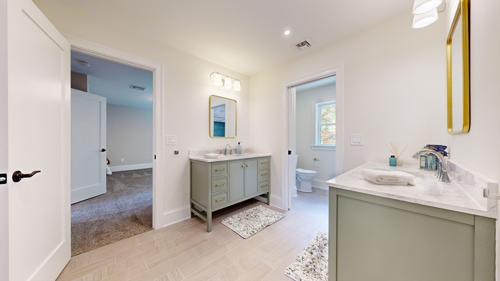8 Charles Street North Reading, MA 01864 - Photo 30 of 42 a bathroom with a sink double vanity and a mirror