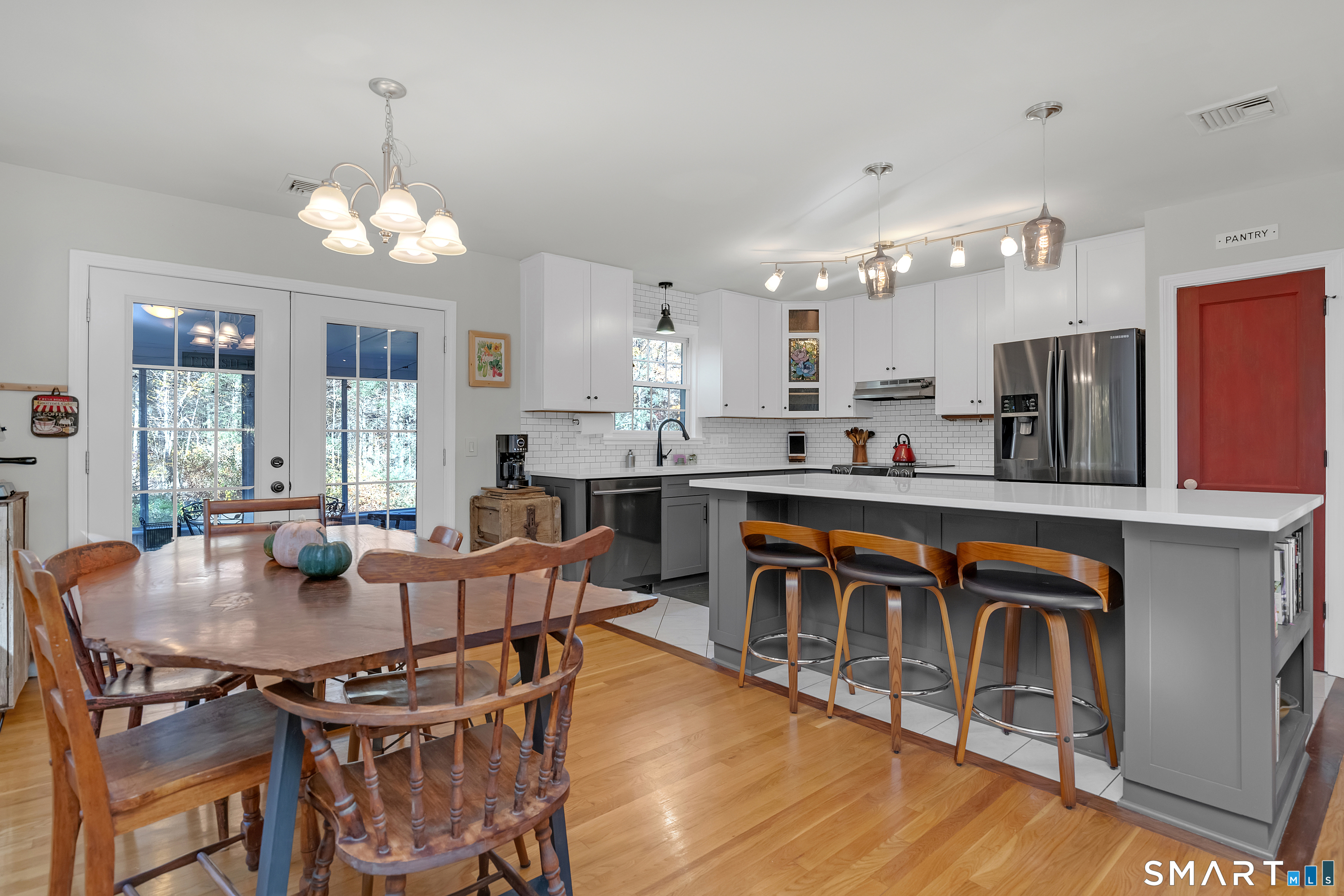 16 Marion Road Bethany, CT 06524 - Photo 13 of 40 a dining room filled chandelier and wooden floor