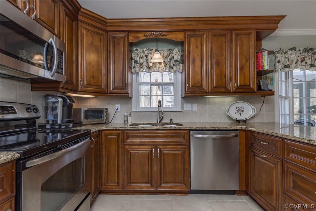 844 Watch Hill Road Midlothian, VA 23114 - Photo 26 of 50 a kitchen with stainless steel appliances granite countertop a stove sink microwave and cabinets
