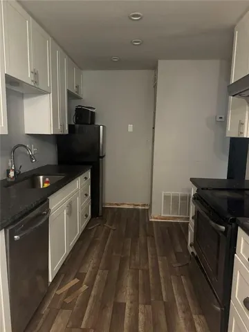 a kitchen with a sink stove and cabinets