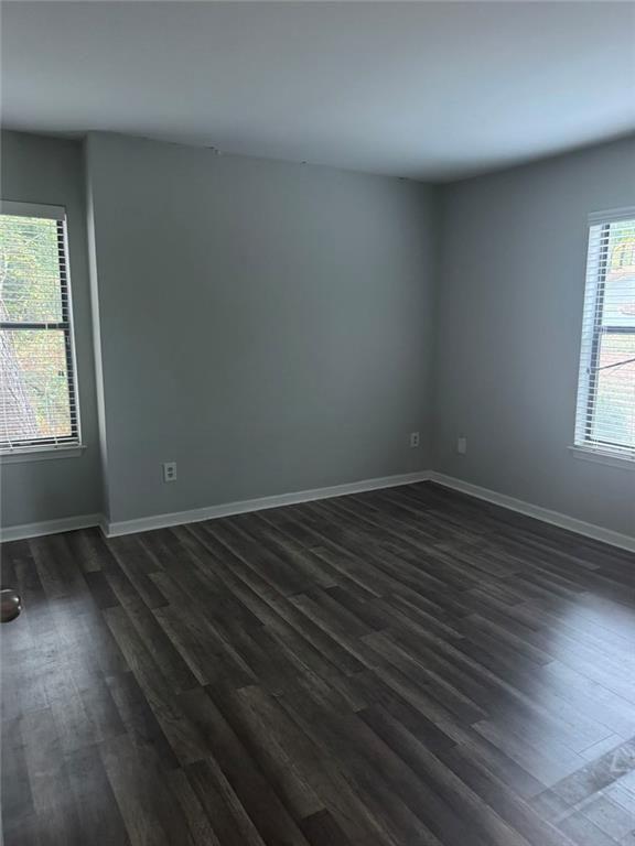 2401 Huntingdon Chase Atlanta, GA 30350 - Photo 3 of 3 an empty room with wooden floor and windows